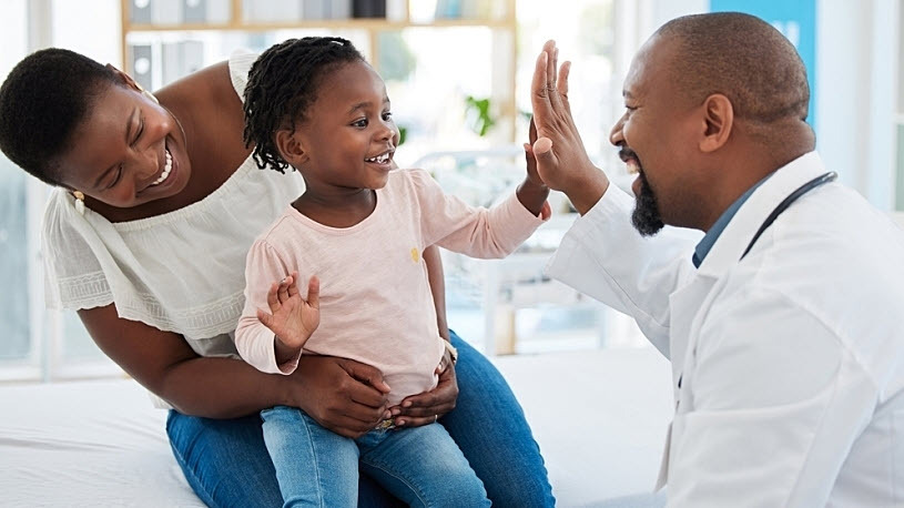 Image of mother with child giving doctor high five gesture