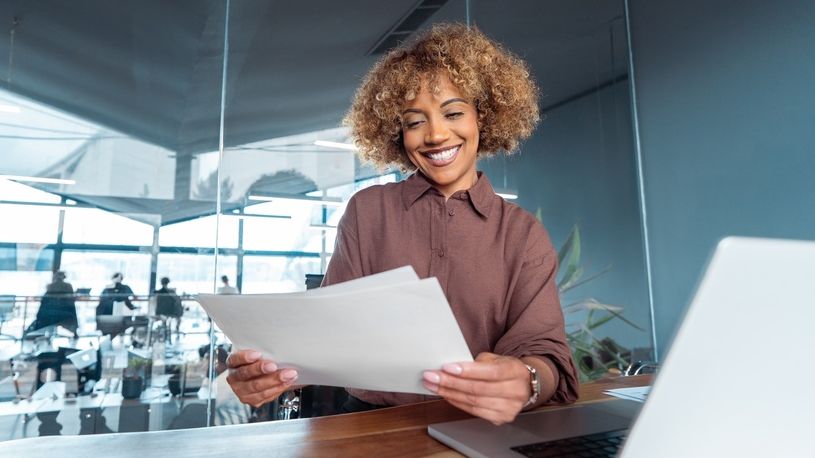 Happy business owner reviewing reports