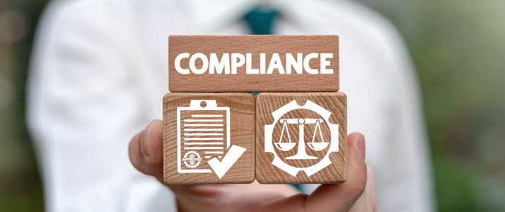 man holding blocks showing the word compliance scales of justice man holding blocks showing the word compliance scales of justice