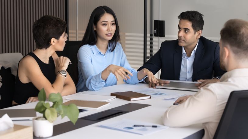 Serious female leader discusses change with her team