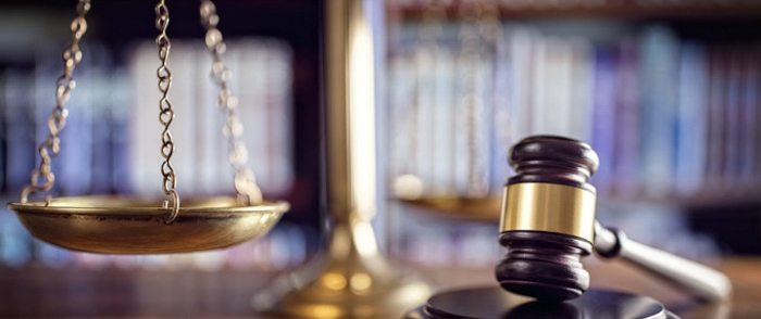 4 Reasons You Need Compliance Technology A judge's gavel sits on a desk.