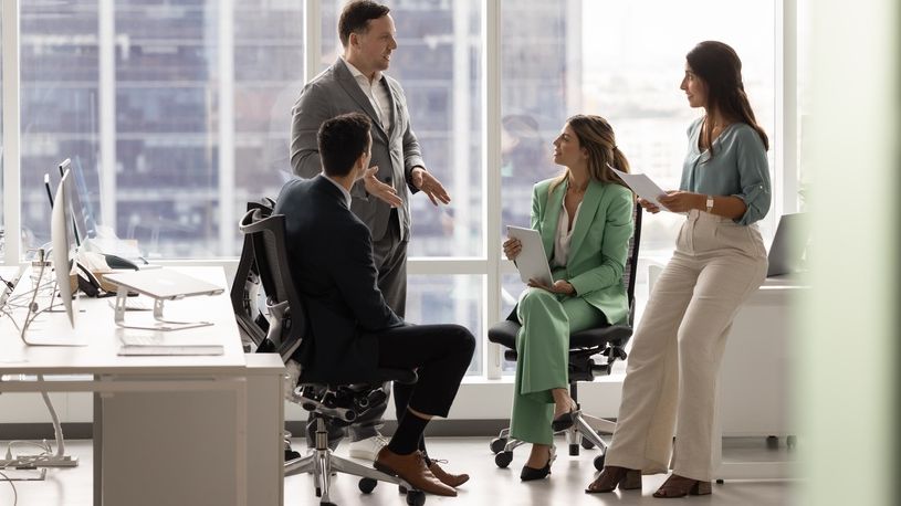 Leader meeting with team in high-rise office