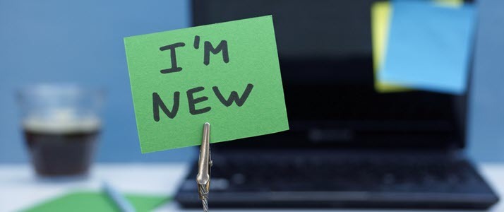 Im new written on sticky note in front of laptop Im new written on sticky note in front of laptop
