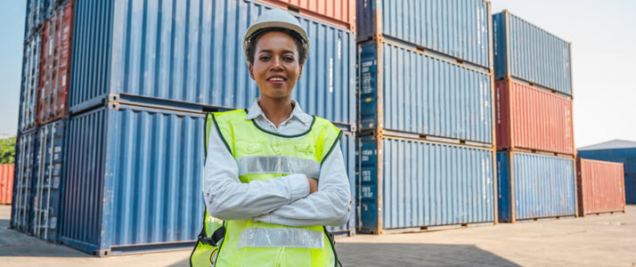 Black forewoman in front of shipping containers On the Money Gaining Ground With Global Payroll Solutions
