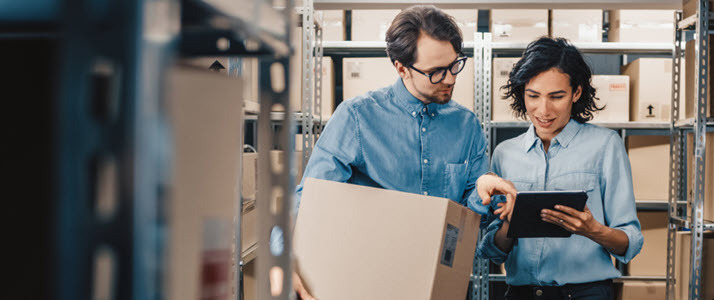 Never Make These 9 Mistakes with Exempt Employees Female manager with computer tablet talking to male worker carrying box