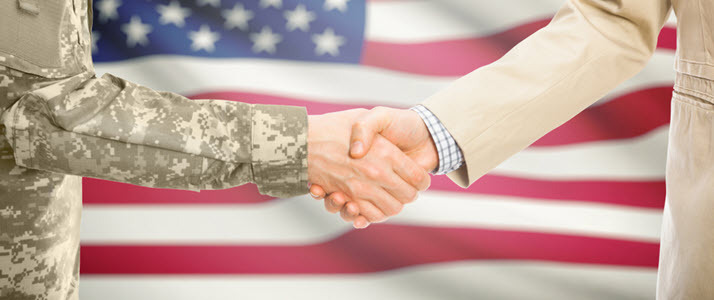 Vets Transitioning From the Military to Business A veteran and businessman shaking hands with US flag in background