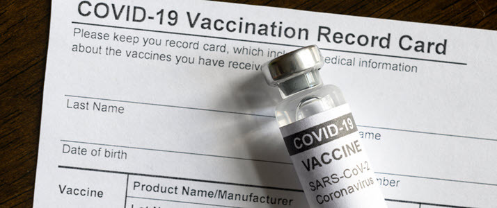 A COVID19 vaccine vial sits on vaccine record card
