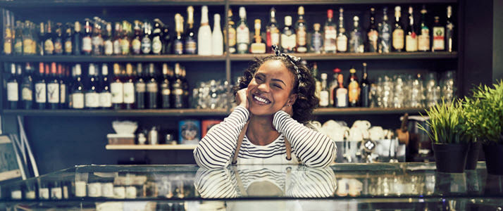 small business owner standing behind cafe counter small business owner standing behind cafe counter