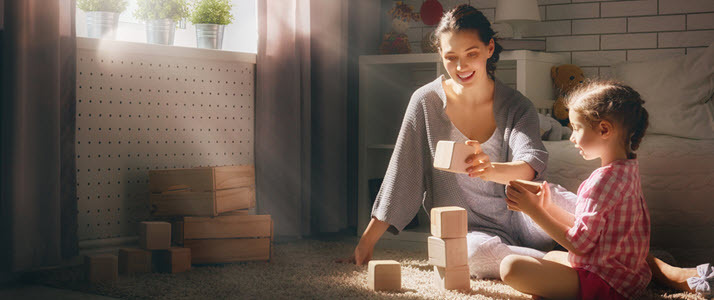 Mother and child playing with blocks on floor Mother and child playing with blocks on floor