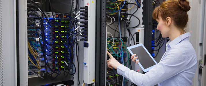 female IT tech working in server room female IT tech working in server room