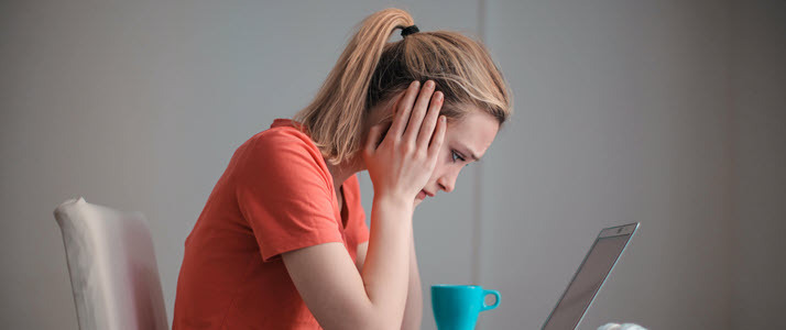 Prioritizing the ADA and Mental Health A woman sits at a desk looking exasperated