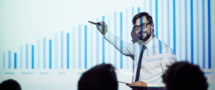 male businessman presenting chart to audience male businessman presenting chart to audience