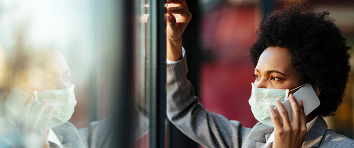 pesive african american worker in mask talks on mobile phone pesive african american worker in mask talks on mobile phone