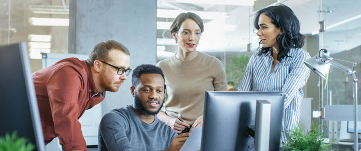 Improving Diversity and Inclusion A diverse group of office workers reviewing people analytics reports
