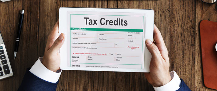 hands holding form that reads tax credits