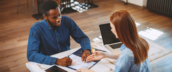 young black man and young white woman at desk job interview young black man and young white woman at desk job interview