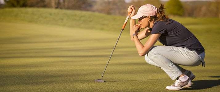 Young women analyzing shot on golf course