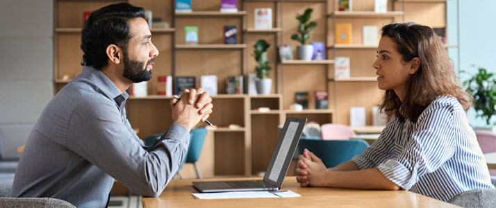 Male manager interviewing female applicant in casual office Male manager interviewing female applicant in casual office