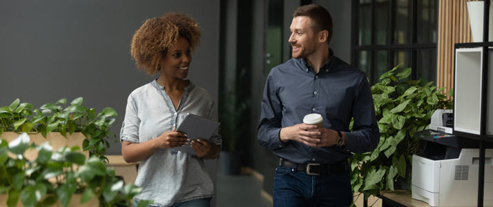 male and female coworkers walking in office