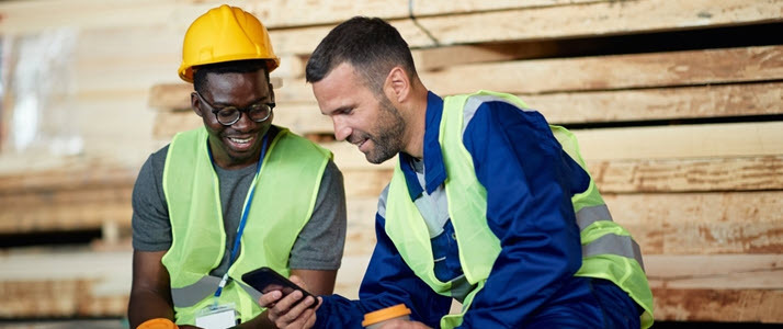 This Labor Day Employers Step Up as Workers Stand Up Two workers laugh with each other while sitting and enjoying a break