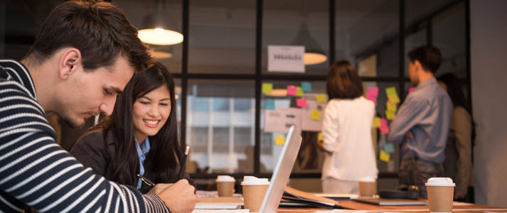 smiling diverse coworkers in conference room sticky notes smiling diverse coworkers in conference room sticky notes