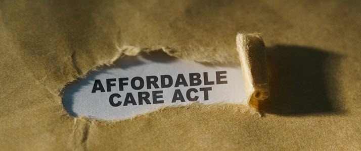 affordable care act printed title behind torn brown paper affordable care act printed title behind torn brown paper