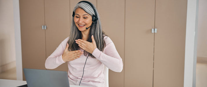 Woman wearing headset using ASL to communicate video meeting Woman wearing headset using ASL to communicate video meeting