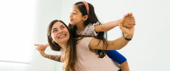playful happy mom playing with daughter on back playful happy mom playing with daughter on back