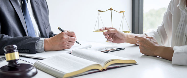 Professionals at desk with law book discussing legislation change Results From the 2022 Retirement Confidence Survey