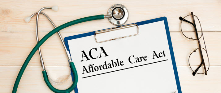 Clipboard with paper on which ACA Affordable Care Act is printed