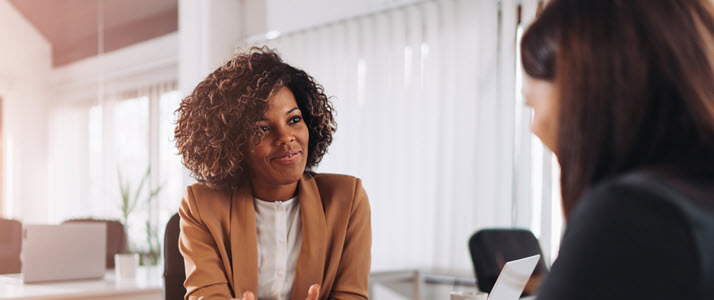 Rescind an offer Two women sit in an office during a job interview