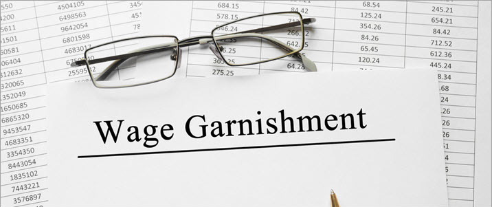 image of spreadsheet and reading glasses with Wage Garnishment