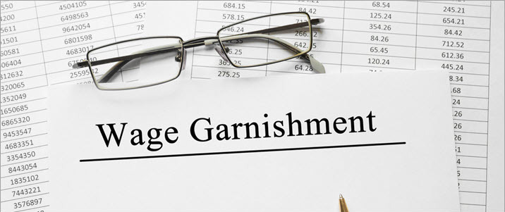 image of spreadsheet and reading glasses with Wage Garnishment image of spreadsheet and reading glasses with Wage Garnishment