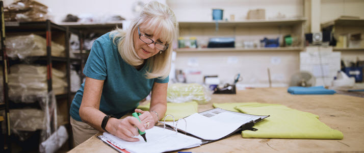 senior business woman checking notebook on worktable