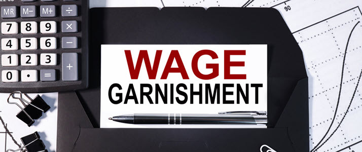 calculator notebook and calendar with wage garnishment words calculator notebook and calendar with wage garnishment words