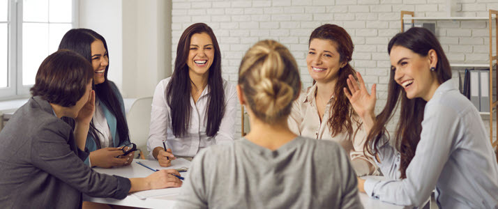 Womens History Month Six women sit at a round conference table in an office