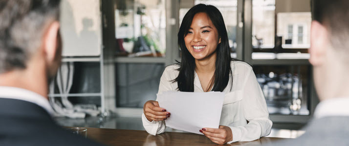 cheerful Asian woman in job interview with two male managers cheerful Asian woman in job interview with two male managers