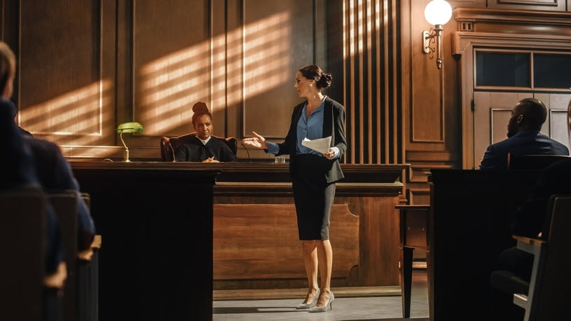 Female prosecutor presenting a case in a court in front of judge