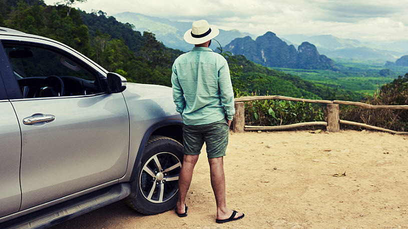 Back view of a man pondering his travels and adventures ahead Back view of a man pondering his travels and adventures ahead