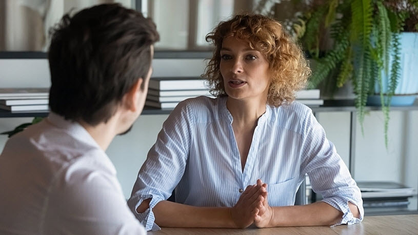 man and woman professionals having candid conversation in office