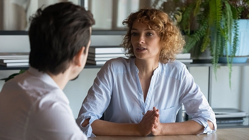 man and woman professionals having candid conversation in office man and woman professionals having candid conversation in office