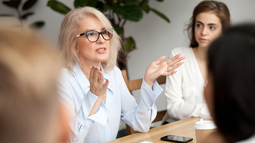 Decorative image: businesswoman leading serious discussion 5 questions to ask a potential payroll tax provider.