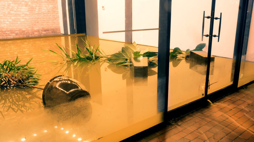 image of a flooded office lobby with damage that will require insurance claim