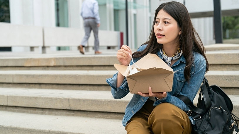 Asian Korean female professional enjoying lunch outside office