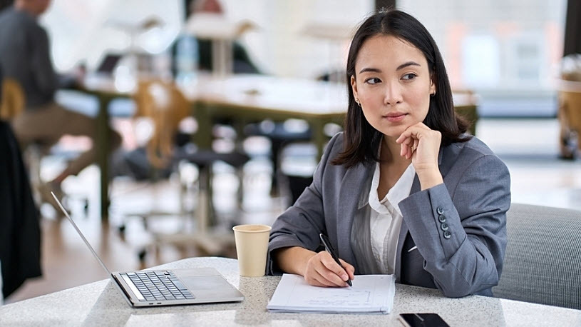 young thoughtful Asian businesswoman executive in office young thoughtful Asian businesswoman executive in office