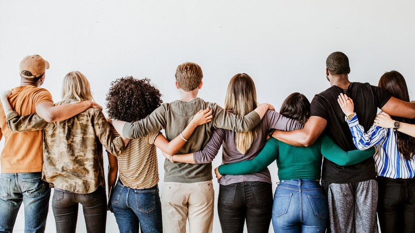 rearview of diverse people hugging each other