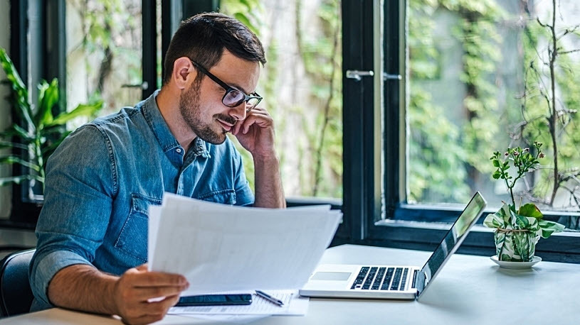 male manager documenting payroll processes in office male manager documenting payroll processes in office