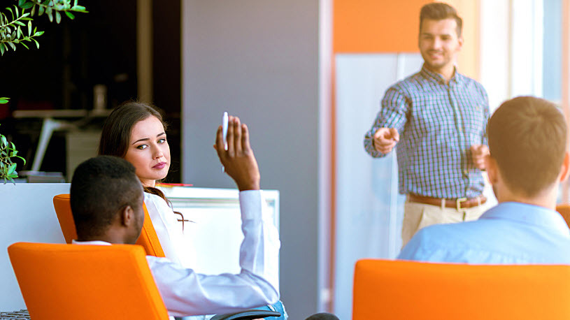 Black businessman raising hand to ask question in meeting Black businessman raising hand to ask question in meeting