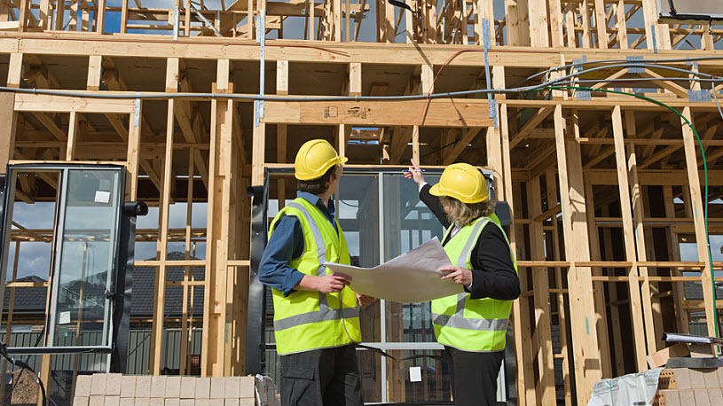 Male engineer and female construction worker discussing plans Male engineer and female construction worker discussing plans