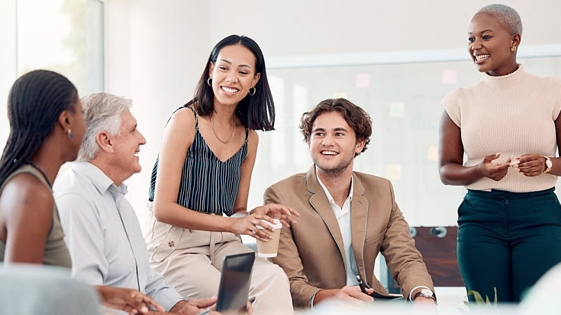 A team of diverse business colleagues smiling and collaborating A team of diverse business colleagues smiling and collaborating